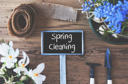 a sign saying spring cleaning on a decorated table