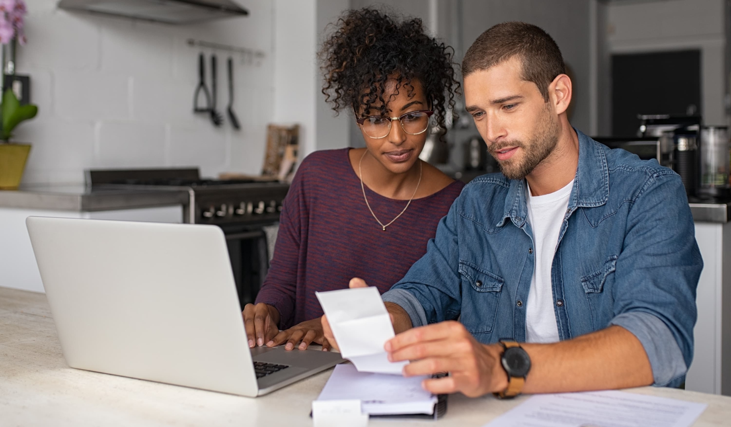 a couple reviewing financial statements at home