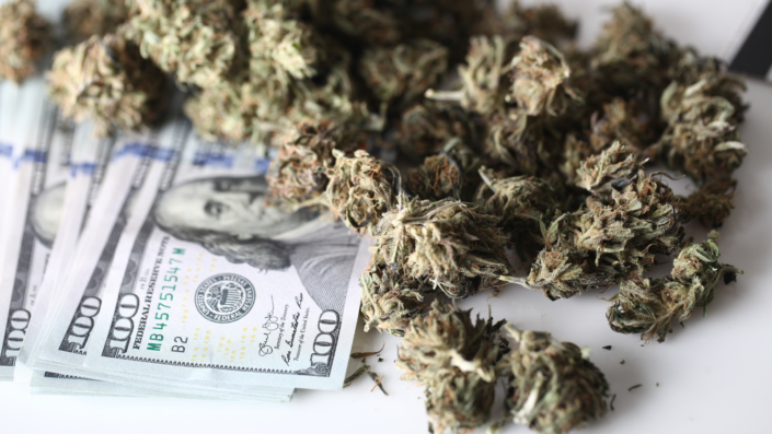 marijuana next to 100 dollar bills