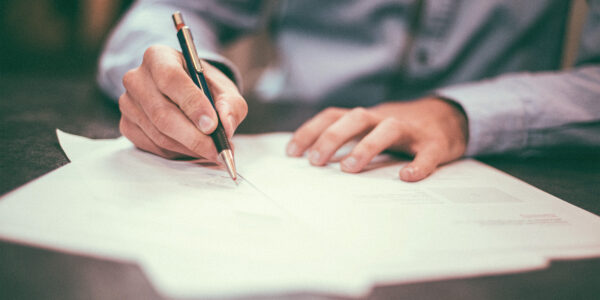 a business professional signing documents