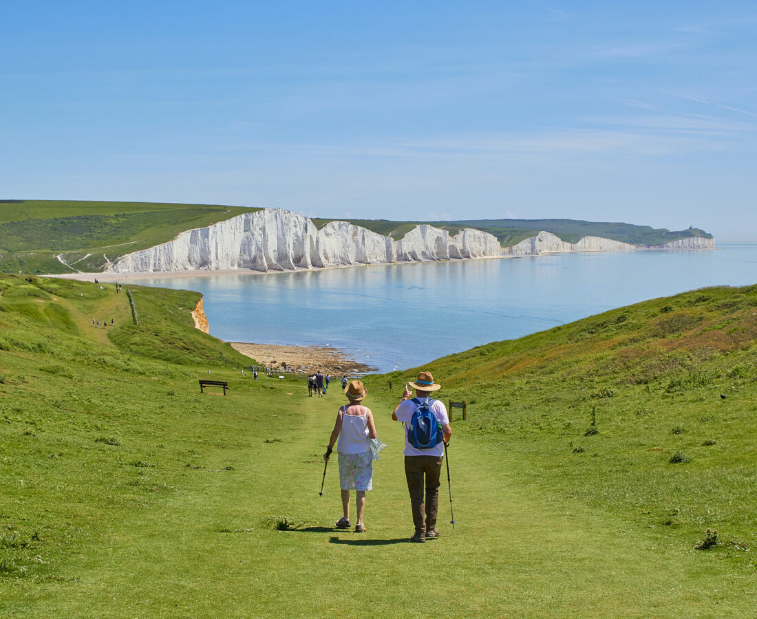 retirees taking a hike at a scenic shoreline