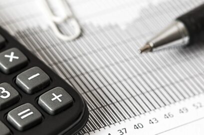 a banner image showing a pen and calculator sitting on a document