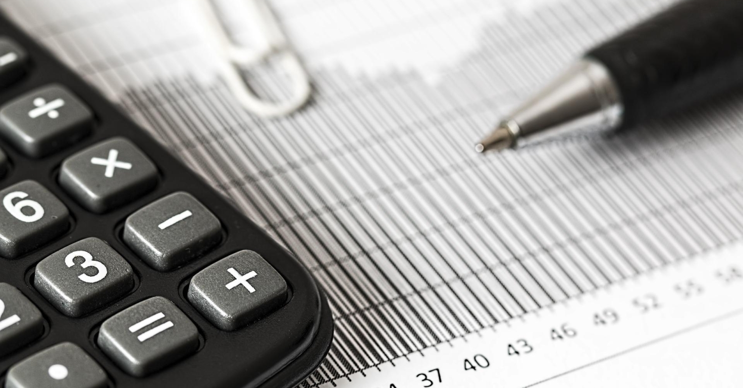 a banner image showing a pen and calculator sitting on a document