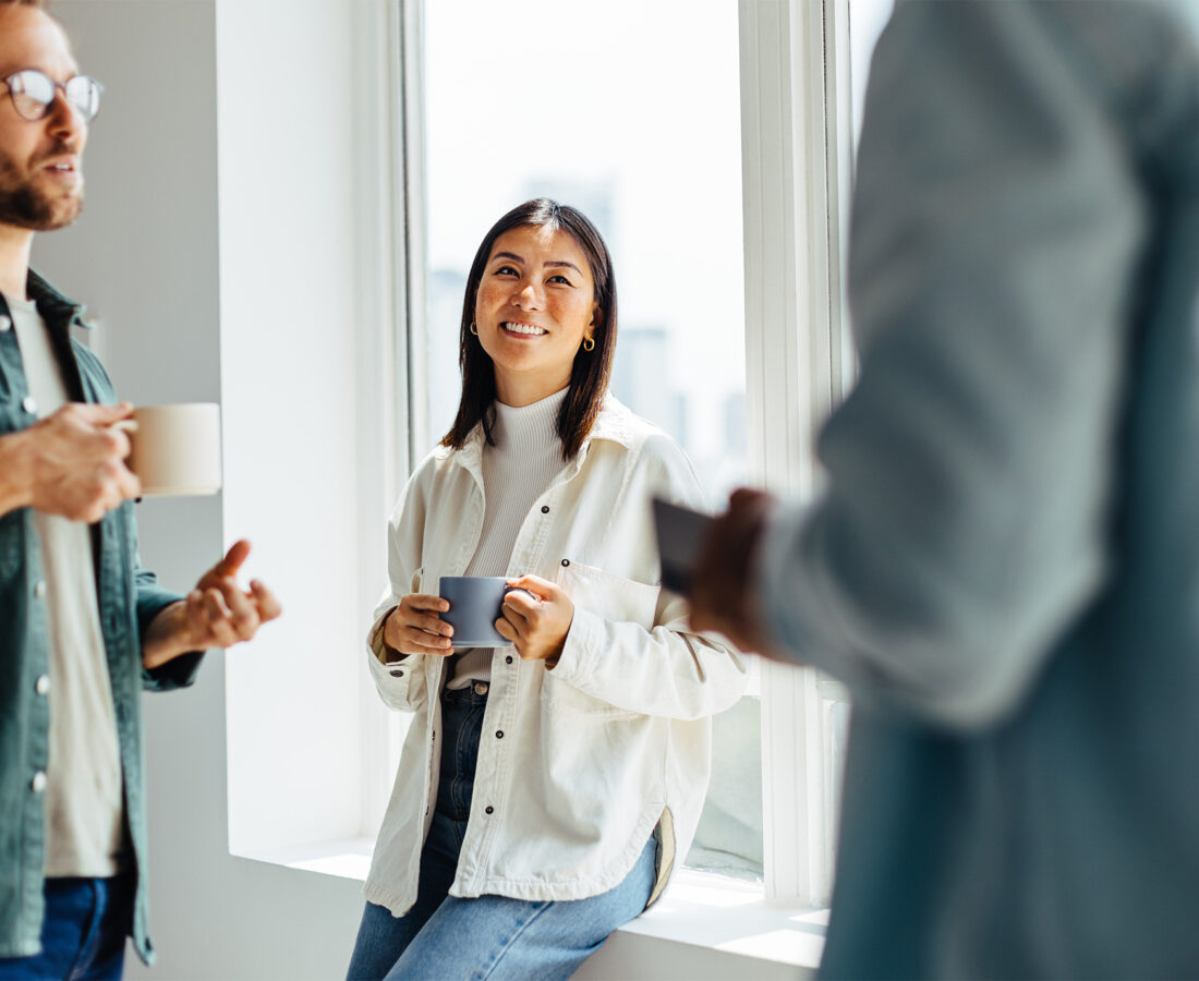 team members talking casually in the office