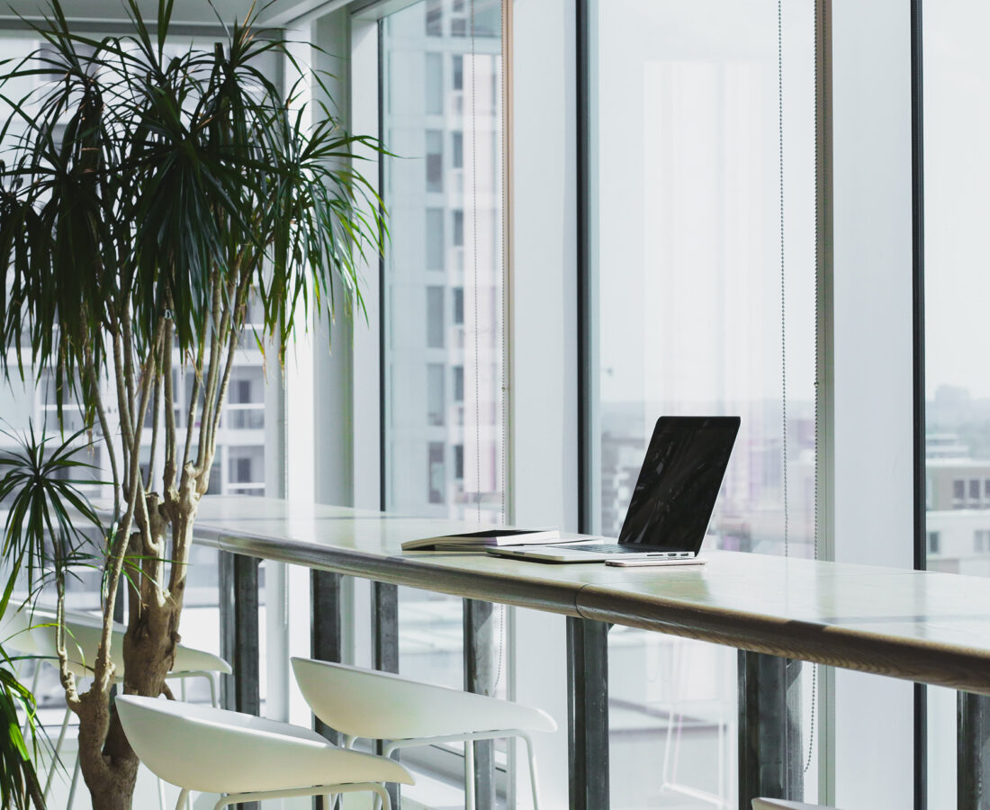 a laptop sitting on a bar in an office space