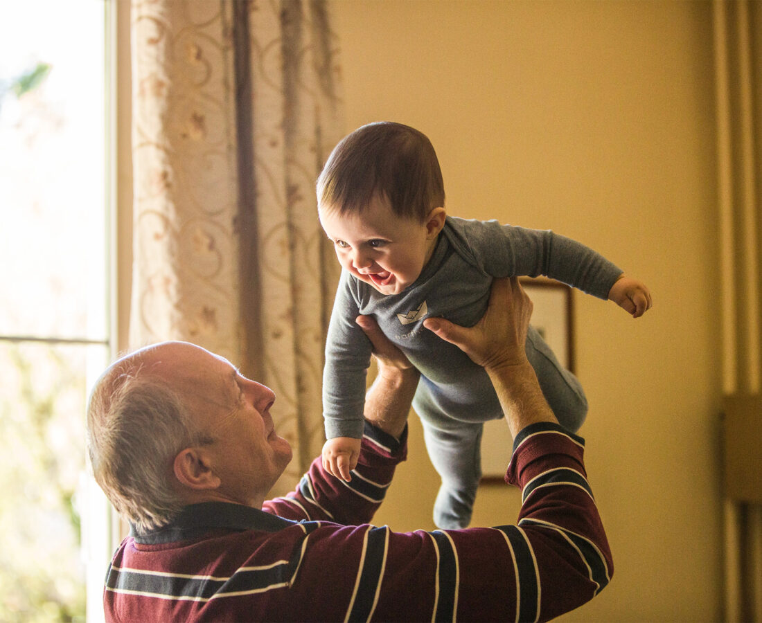 a grandpa holding his grandson