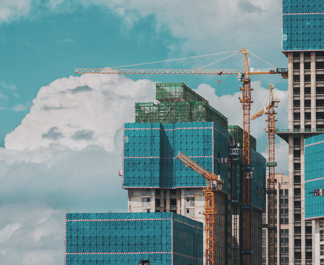 skyscrapers being built with cranes