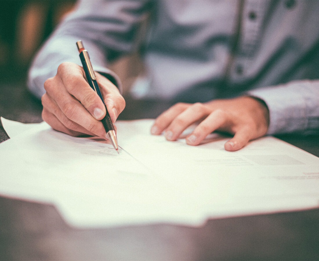 a business professional signing documents