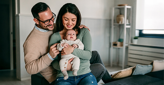 Parents and their child in a bedroom
