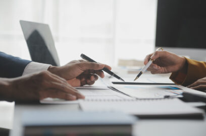 Consultant and business owner review financial reports for successful