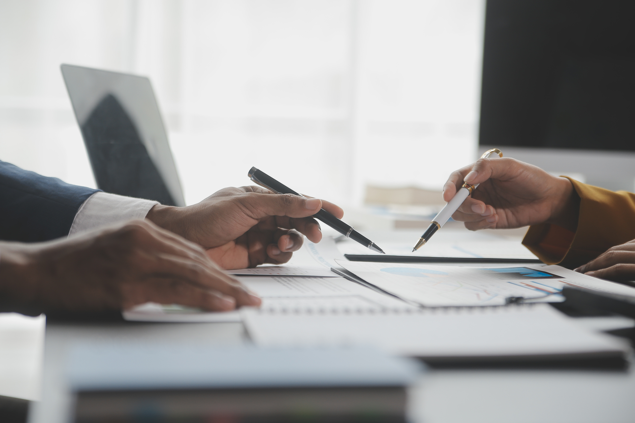 Consultant and business owner review financial reports for successful