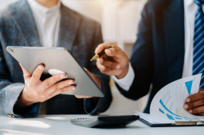 Businessman and team analyzing financial statement Finance task. with smart phone and laptop and tablet. Wealth management concept