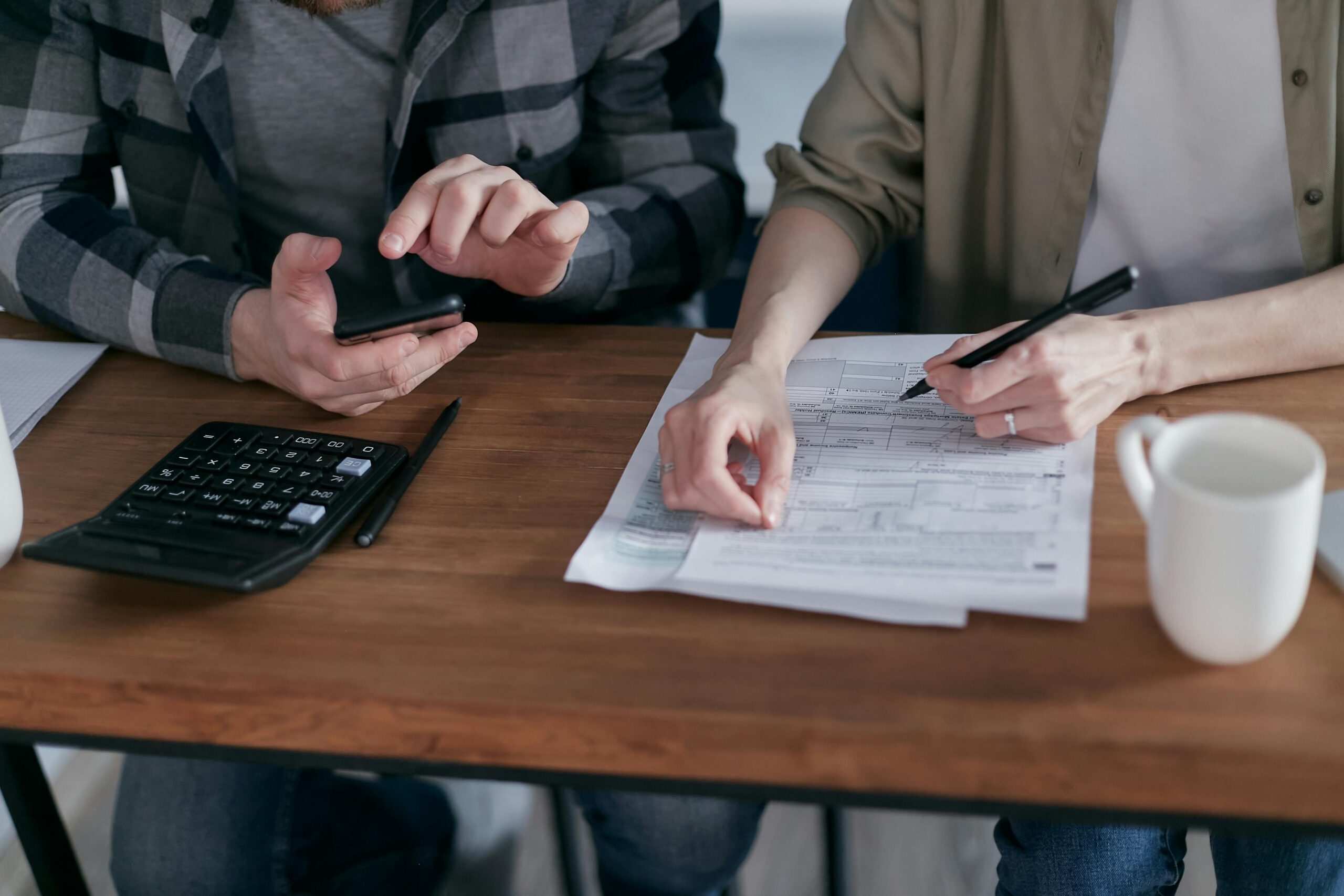 2 business owners reviewing tax documents and QBI deductions