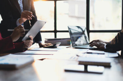 Business meeting, Company executives meeting discussing strategic analysis and business planning, group of people working with paperwork on a board room table at a business presentation or seminar.