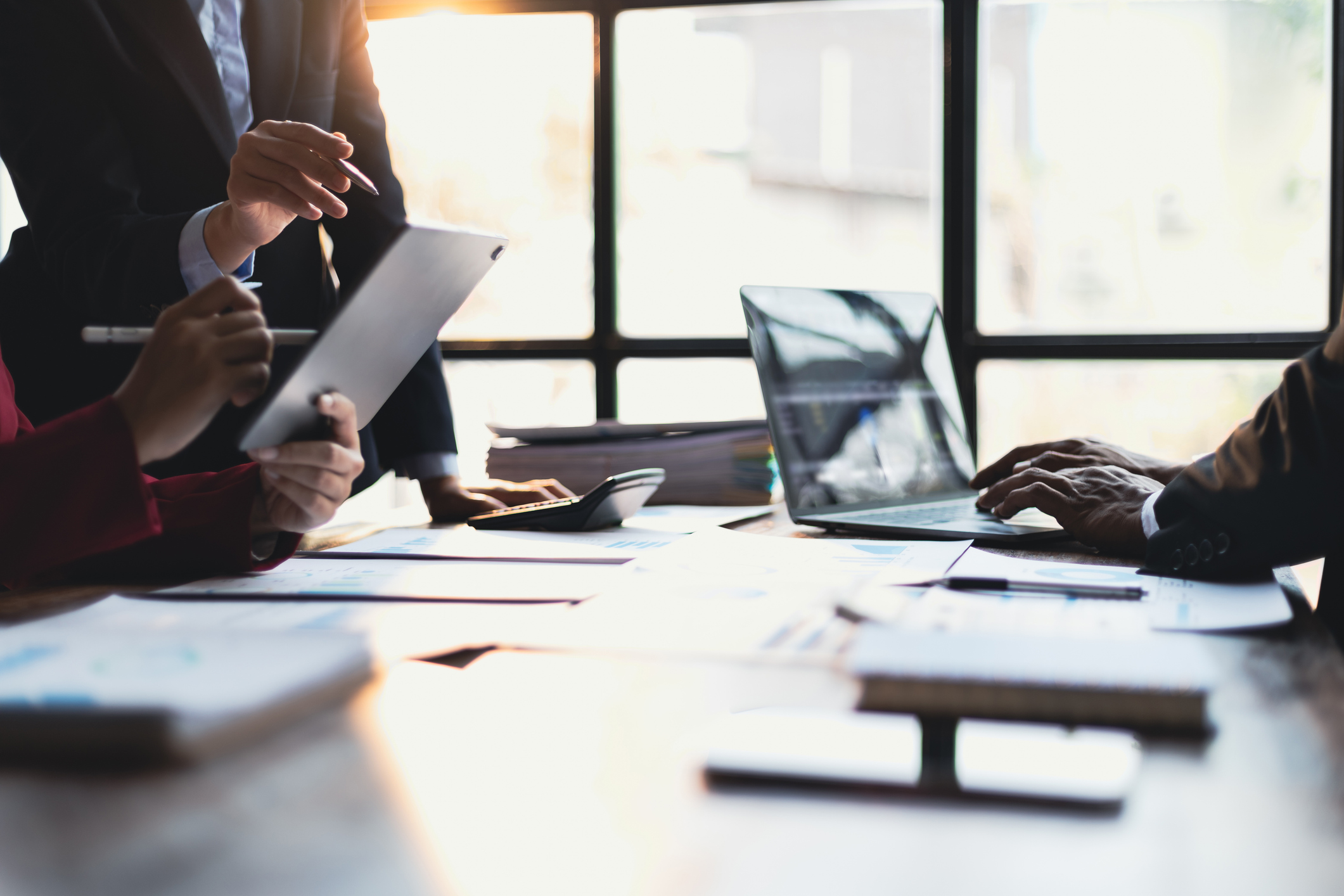 Business meeting, Company executives meeting discussing strategic analysis and business planning, group of people working with paperwork on a board room table at a business presentation or seminar.