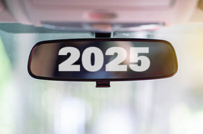 Car rear view mirror inside the car that says 2025.