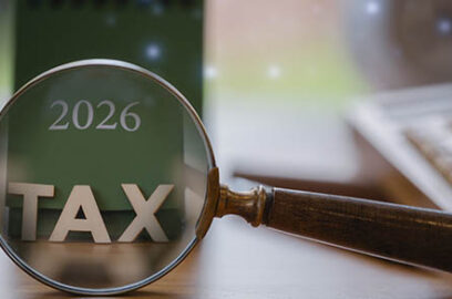 2026,Tax,Concept,With,Magnifying,Glass,Highlighting,Tax,On,A