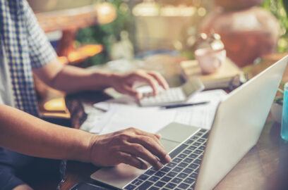 Laptop, typing, keyboard, calculator, paperwork, desk