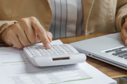 Desk, Laptop, person, clicking, calculator, papers