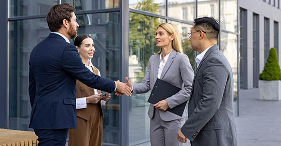 Interracial,Group,Of,Young,Business,People,Standing,On,Street,Outside