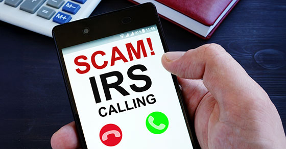 Hand, holding, cell phone, screen, text, words, Scam, IRS, Calling
