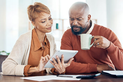 Review, Social Security, Benefits, Man and Women, Sitting at Kitchen Table, Drinking Coffee,