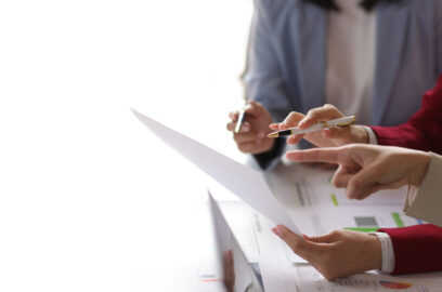 Team of business professionals looking over financial paperwork