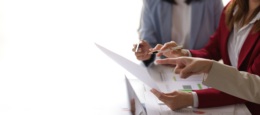 Team of business professionals looking over financial paperwork