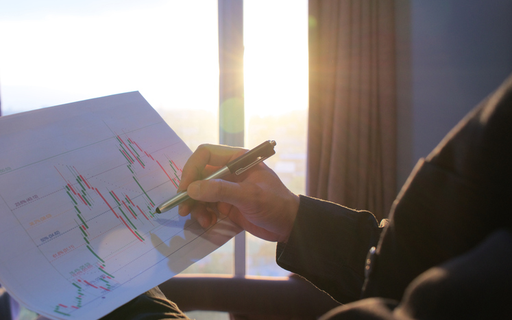 Closeup of someone reviewing financial charts