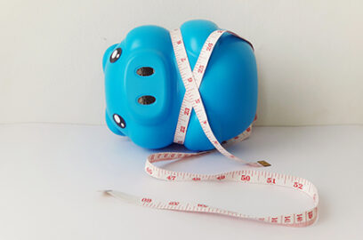 blue piggy bank, measuring tape, retirement savings, financial planning, tax-deferred retirement accounts, savings measurement