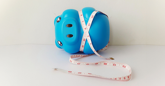 blue piggy bank, measuring tape, retirement savings, financial planning, tax-deferred retirement accounts, savings measurement