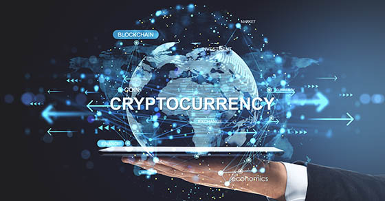 Businessman hand holding tablet with digital globe showing cryptocurrency, blockchain, and finance network on dark background, concept of crypto