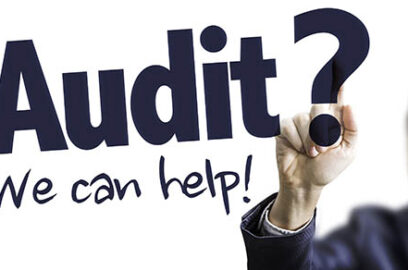 Business professional, writing on white board, text: Audit? We can help!