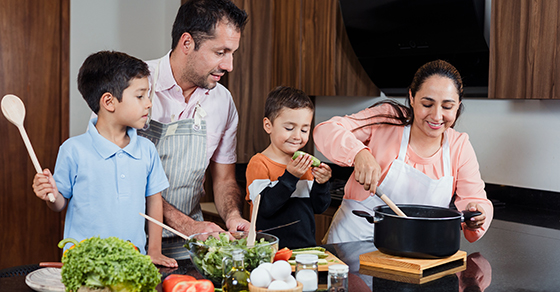 Family, in the kitchen, Mom, Dad, Son, Daughter, making dinner.